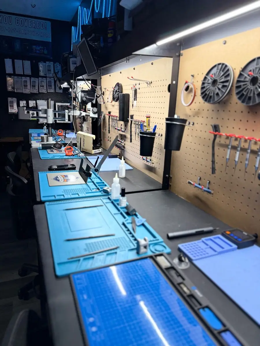 Repair workbenches with microscopes and tools inside OneClick Phone Repairs in Fullerton, CA