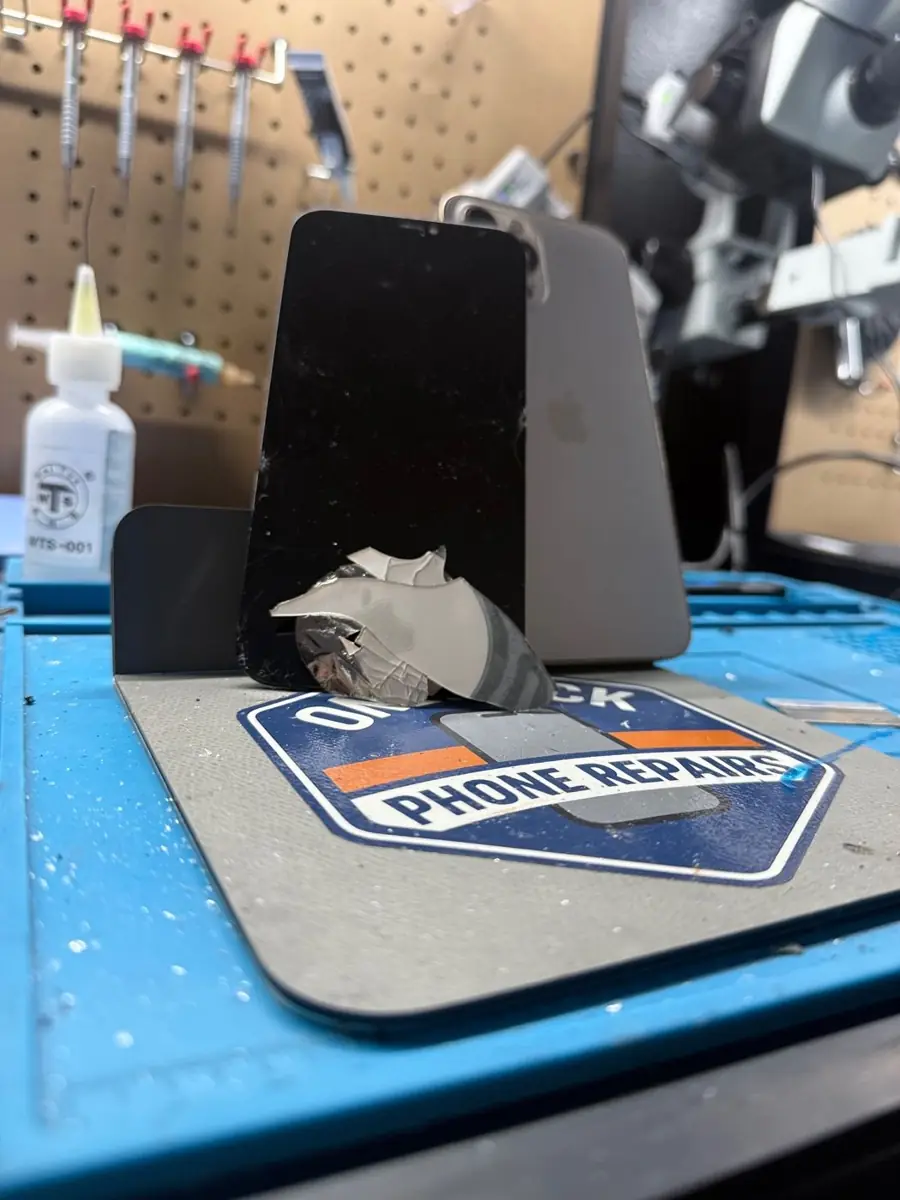 Shattered iPhone back glass removed during repair at OneClick Phone Repairs in Fullerton, CA